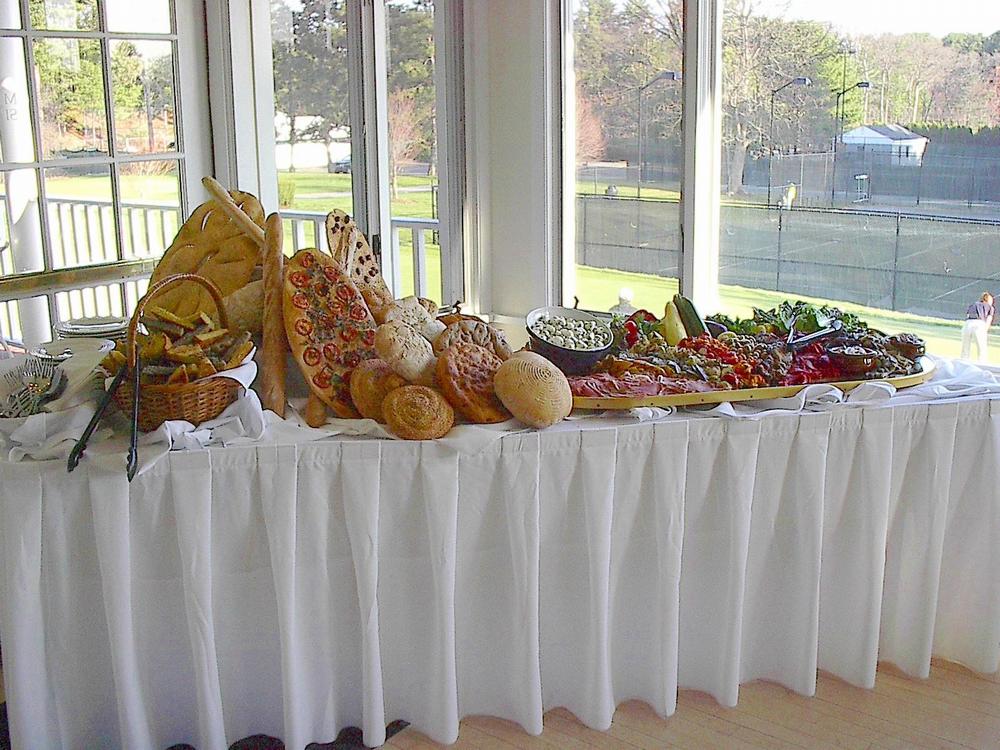 A variety of fresh baked breads and antipasto, beautifully displayed.