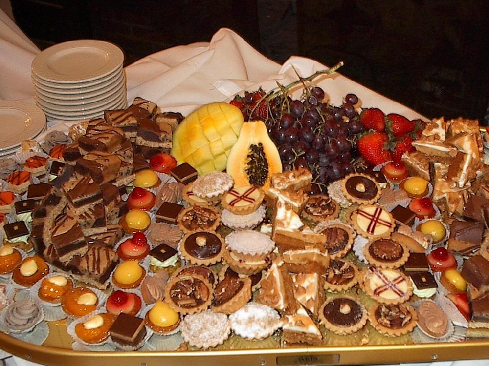 An incredible variety of bite-sized sweets, accompanied by fresh fruit.